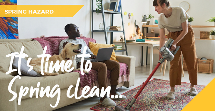 Couple cleaning whilst dog sits on sofa
